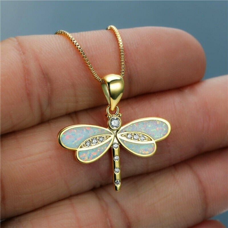 Nakkede med en guldfarvet libelle med opal